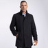 A black wool jacket with a high collar and front pockets, worn by a model against a light background.
