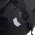 A black duffle bag with a textured surface and adjustable straps, featuring a small logo.