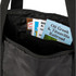A black duffle bag interior with various pamphlets and brochures visible inside.