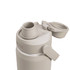 A drink bottle in a light beige colour with a flip-top lid and a built-in straw, featuring a logo.