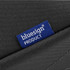 A textured black toiletry bag with a blue label indicating it is a bluesign product.