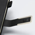 A black diary with a silver metal tab and textured cover, featuring a brand logo.