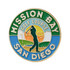 A round, soft enamel golf ball marker featuring green, blue, and orange colours, with a golfer silhouette and a logo.