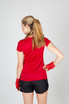 A red Women's Accelerator Cool-Dry T-shirt displayed from the back, paired with black shorts and red gloves.