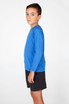 A long sleeve T-shirt in bright blue, featuring a logo, paired with dark shorts, displayed on a model.