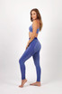 A model wears a blue seamless crop top paired with matching blue leggings, showcasing a sporty design.