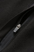 A close-up of a black polar fleece half zip top featuring a silver zipper detail and a soft texture.