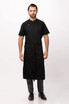 A black chef bib apron worn by a model, featuring a sleek design and a logo.