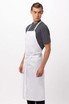 A white bib apron worn by a model, featuring a simple design and adjustable ties. It has a logo on it.