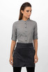 A woman models a grey button-up shirt paired with a black half bistro apron. The apron has a logo.