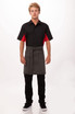 A man wearing a black and red shirt and a grey Dorset Half Bistro Apron. The apron has a logo.