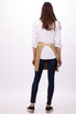 A bistro apron in beige worn over a white shirt, featuring a back tie and a circular loop.