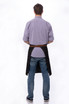 A person wearing a black Memphis Bistro Apron over a light purple shirt, facing away. The apron features a logo.