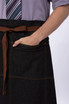 A denim bistro apron in dark blue with a brown tie and pocket, featuring a simple design.