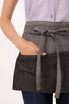 A grey waist apron with a tied belt and front pockets, made from a textured fabric.