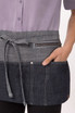 A denim apron featuring a dark and light blue design with a front pocket and a zippered compartment.
