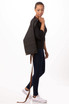 A dark grey waist apron with brown straps, being worn by a model standing sideways.