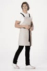A light grey cross back apron with black straps worn by a person. The apron has a logo on it.