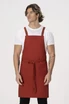 A red cross back apron is worn by a male model, with a simple design and adjustable straps.