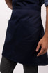 A navy blue bib apron featuring two large pockets and a branding logo.