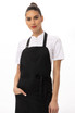 A black Brio Bib Apron worn by a model, featuring a stylish design and a logo.