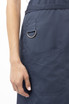 A navy blue bib apron featuring a side pocket and a metal ring detail.