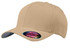 A tan Flexfit cap with a rounded crown and a curved brim, featuring a branding logo.
