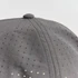A grey cap with a perforated design, featuring small holes across the fabric. It has a rounded top button.