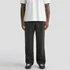 Relax Faded cuffless track pants in black, styled with a white T-shirt and navy shoes, featuring a logo.
