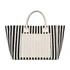 A striped tote bag in black and white with a plain cream-coloured front pocket and handles. It has a logo.