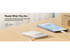 A white power bank on a wooden surface, connected to a smartphone, with a visible logo.