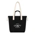 A black tote bag with cream handles and a front pocket, featuring a logo on the front.