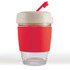 A reusable coffee cup with a clear base, a white lid, and a red silicone band and straw.