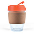 A reusable coffee cup featuring a clear body, an orange lid, and a cork band for insulation.