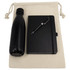 A cotton drawstring bag containing a black insulated bottle, a black journal, and a silver pen.
