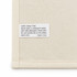 A cream cotton tea towel featuring a care label with washing instructions and a brand logo.