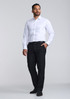 A classic fit long sleeve shirt in white, paired with black trousers, worn by a man standing confidently.