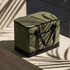 A cooler bag in olive green with black detailing, featuring two handles and a rectangular shape.