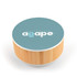 A round speaker and wireless charger with a bamboo base and a teal top featuring a logo.