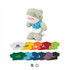 A light green shark plush toy wearing a blue shirt, with various colourful shirts displayed below.