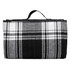 A folded picnic rug featuring a black and white check pattern, with a carrying handle on top.