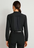 A black long sleeve blouse featuring a button-up design and a pleat detail at the back.