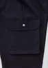 A pair of black cargo pants featuring a large side pocket with a snap closure and a smooth fabric finish.