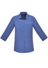 A blue women's button-up shirt with 3/4 sleeves and a chest pocket, featuring a logo.