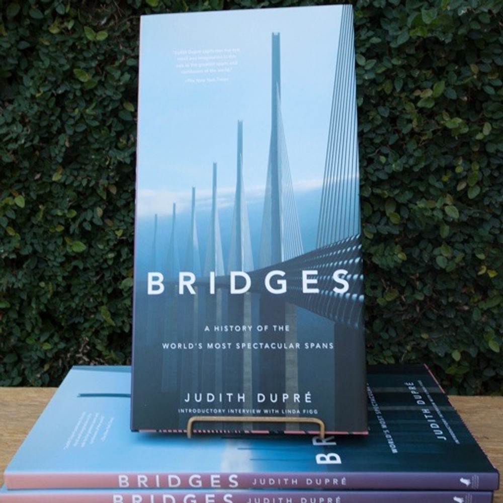 From the best-selling author of Skyscrapers comes the much-anticipated twentieth-anniversary edition of her magnificent chronological tour of the world's most significant and eye-popping spans, now in color and bigger than ever.  This visual history of the world''s landmark bridges is updated and expanded since its initial publication twenty years ago, with all-new photographs and features on cutting edge work by international superstars of architecture and engineering. Spanning two-thousand years of technological and aesthetic triumphs, Bridges stands as the most thorough, authoritative, and gorgeous book on the subject. With its dynamic design and oversized format, the book is as dramatic as the structures it celebrates. Breathtaking photographs capture the bridges' details as well as their monumental scale; location maps and architectural drawings invite you behind the scenes as new bridges take shape; and lively commentary on each explores its historical context and significance. Throughout, informative profiles, sidebars, and statistics make BRIDGES an invaluable reference as well as a visual feast. Technological advances, structural daring, and artistic vision have propelled the evolution of bridge designs around the world. The last thirty years has seen the construction of masterpieces such as the Zakim Bridge that changed the city of Boston; Gateshead Millennium Bridge in England, a pedestrian tilt bridge that closes like an eye when it is raised; the Millau Viaduct in Tarn Valley, France, now the tallest cable-stay bridge in world; and the 102-mile Danyang-Kunshan Grand Bridge in China, the longest in the world. This all-new twentieth-anniversary edition features profiles on these amazing spans and on beloved landmarks, such as the Golden Gate and the Brooklyn Bridge, as well as thematic chapters on lighting technologies, military bridges, and bridges in the movies.