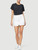 Blanc
A straight cut mini skirt crafted from premium denim in classic bright white. Features a split front-frayed hem.
