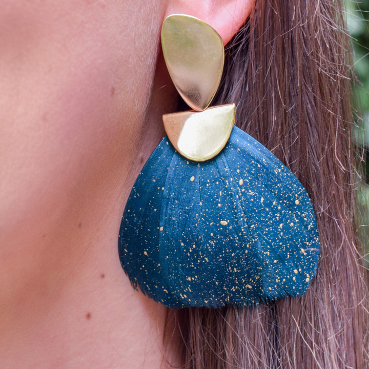 A statement earring that is as light as a feather! These Federika Padula earrings are made with natural, dyed and painted feathers to give a bold statement earring. The post earring sit comfortably in the lobe while the feather give a bold statement look and doesn't weigh down on the pierce hole. 