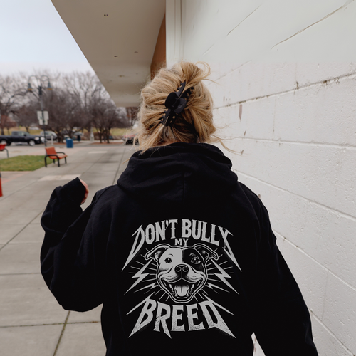 A woman wearing a graphic sweater from our shop