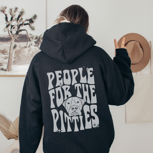 A woman wearing a graphic sweater from our shop 