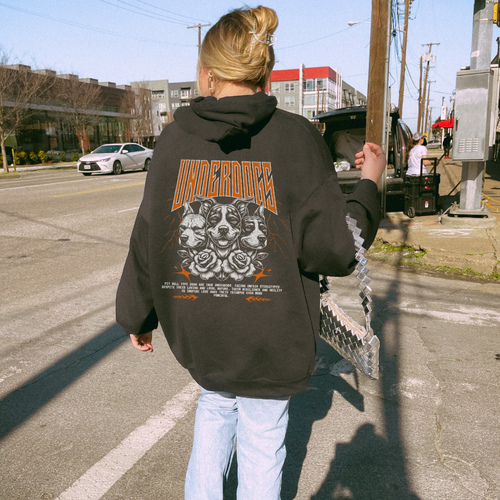 A woman wearing a graphic hoodie from our shop